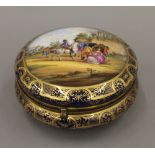 A Dresden painted porcelain box. 18 cm diameter.