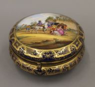 A Dresden painted porcelain box. 18 cm diameter.