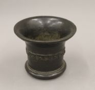 A 17th century bronze mortar. 14 cm high.