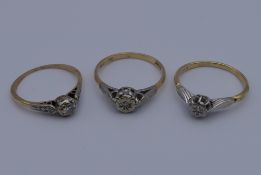 Three 18 ct gold and platinum diamond rings. 7.2 grammes total weight.