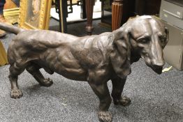 A large bronze model of a dachshund. 112 cm long.