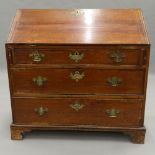 A George III oak bureau. 99 cm wide.