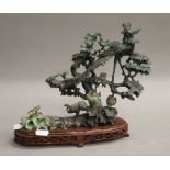 A jade bird group on wooden base. 24 cm high.