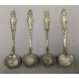 Four Chinese coin set spoons. 14 cm long.