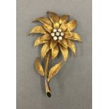 An 18 ct gold diamond set flower brooch. 5 cm high. 11.2 grammes total weight.