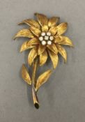 An 18 ct gold diamond set flower brooch. 5 cm high. 11.2 grammes total weight.