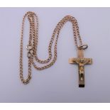 A 9 ct gold crucifix on a 9 ct gold chain. 3 cm high. 10.6 grammes.