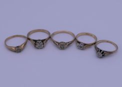 Five 9 ct gold and diamond rings. 10.9 grammes total weight.