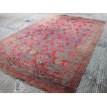 A large red ground rug. 356 cm x 596 cm.