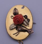 A Victorian unmarked gold and coral pendant/brooch. 4 cm high. 7.7 grammes total weight.