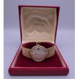 A boxed 9 ct gold Omega wristwatch. 3.5 cm wide. 66.9 grammes total weight.
