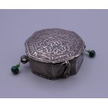 An Afghan white metal box with hinged lid with clasp,