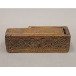 An antique carved treen box. 17 cm long.
