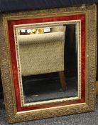 A gilt and red velvet framed wall glass. 82 x 66.5 cm.