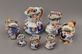 A quantity of 19th century Masons and other Ironstone jugs. The largest 19 cm high.