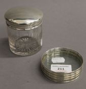 A cut glass and silver topped circular jar,