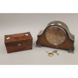 A Victorian rosewood tea caddy and an oak mantle clock. The former 23 cm wide.