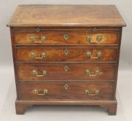 A George III mahogany chest of drawers, with a brushing slide. 83.5 cm wide.