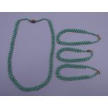 A vintage green coral necklace and three bracelets. The former 42 cm long.