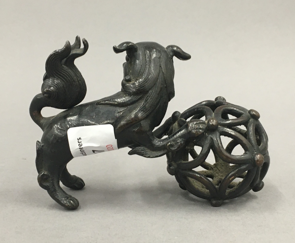 A Chinese patinated bronze model of a dog-of-fo and ball. 11.5 cm long. - Image 2 of 2