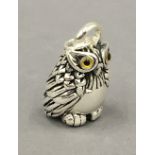 A silver owl form pendant. 4 cm high.