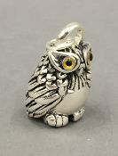 A silver owl form pendant. 4 cm high.