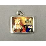 A silver pendant decorated with cats. 3 cm wide.