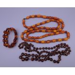 An amber bead necklace, a bracelet and a facet cut glass necklace.