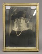 A vintage photograph of a young lady by Bertram Park, signed beneath, framed and glazed.