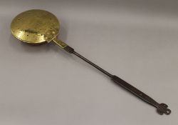 An 18th century brass and steel chestnut roaster. 71 cm long.