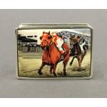 A silver snuff box decorated with horse racing. 5 cm wide.