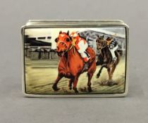 A silver snuff box decorated with horse racing. 5 cm wide.