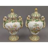 A pair of 19th century hand painted porcelain urns and covers. 32 cm high.