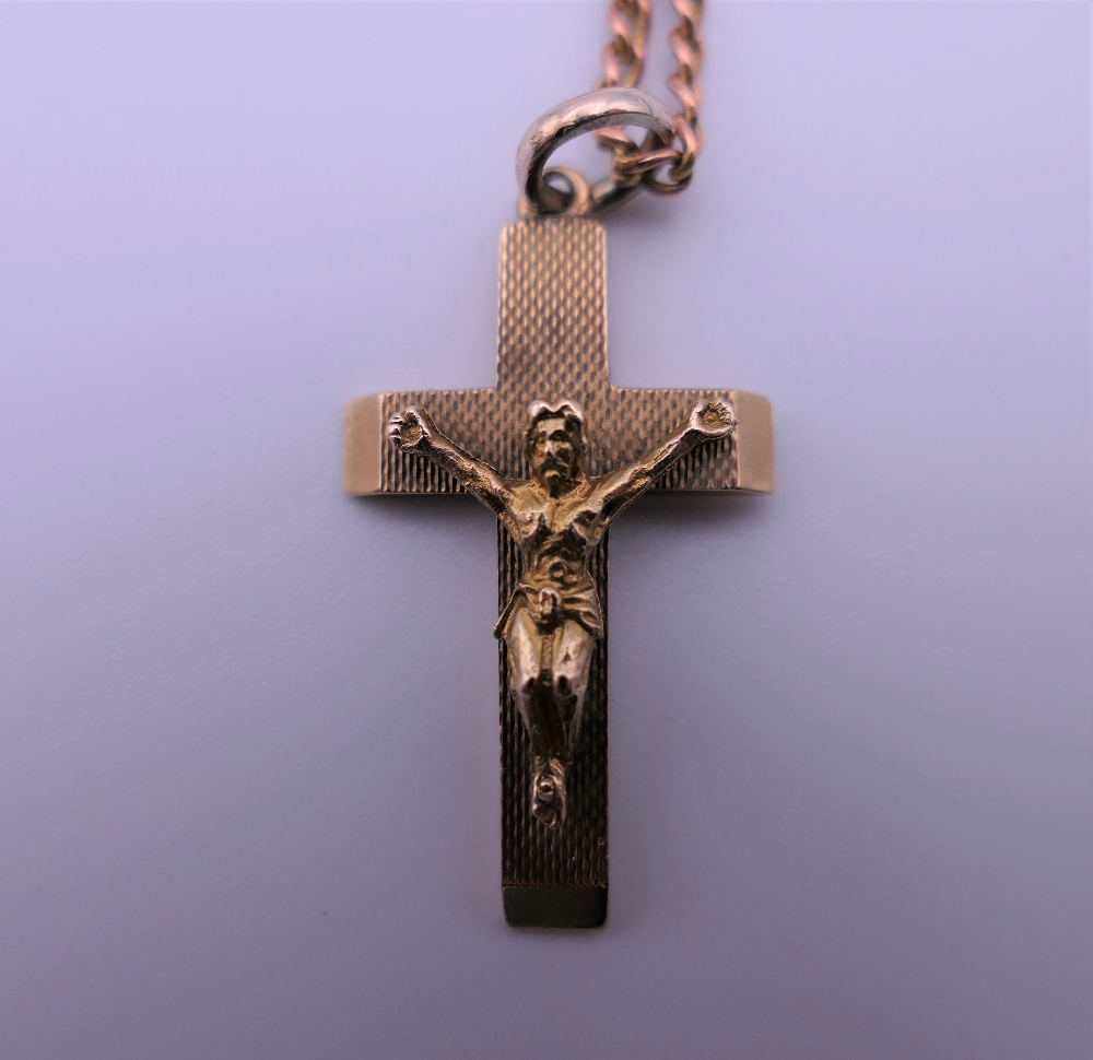 A 9 ct gold crucifix on a 9 ct gold chain. 3 cm high. 10.6 grammes. - Image 2 of 4