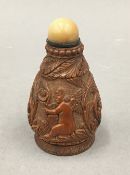 A 19th century carved coquilla nut snuff bottle. 7.5 cm high.