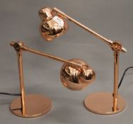 A pair of copper anglepoise lamps