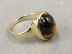 A 9 ct gold tigers eye ring. Ring size P. 3.2 grammes total weight.