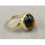 A 9 ct gold tigers eye ring. Ring size P. 3.2 grammes total weight.