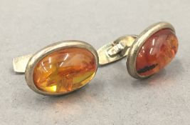 A boxed pair of silver amber cufflinks. Each 2 cm high.