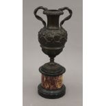 A 19th century cast patinated bronze urn on marble stand. 26 cm high.