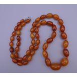 An amber bead necklace. 64 cm long.