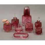 A quantity of cranberry glass dressing table items, etc.