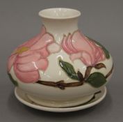 A Moorcroft vase and dish. The former 10 cm high.