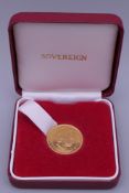 A 2001 gold sovereign, boxed.