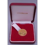 A 2001 gold sovereign, boxed.