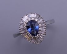 A platinum pear shaped Ceylon sapphire and diamond ring. Ring size Q. 5.7 grammes total weight.