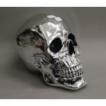 A silvered skull. 19 cm high.
