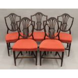 A set of five mahogany Hepplewhite style dining chairs.