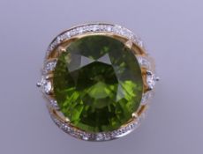 An 18 ct gold tourmaline and multi diamond ring. Ring size O. 15.8 grammes total weight.