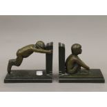 A pair of Art Deco patinated bronze bookends formed as fauns by Paul Silvestre,